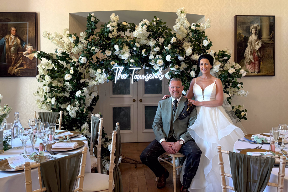 Couple Posing by Floral Decor by Let's Do It Creative